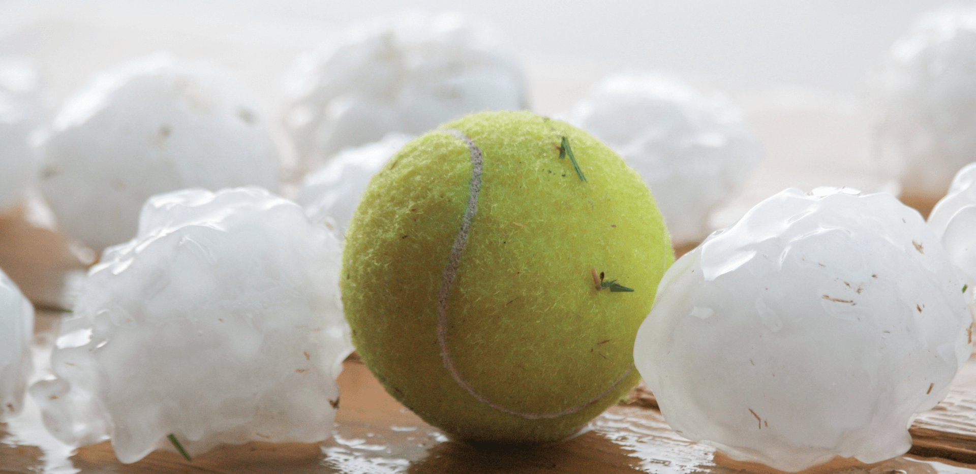 Large Hailstones next to tennis ball