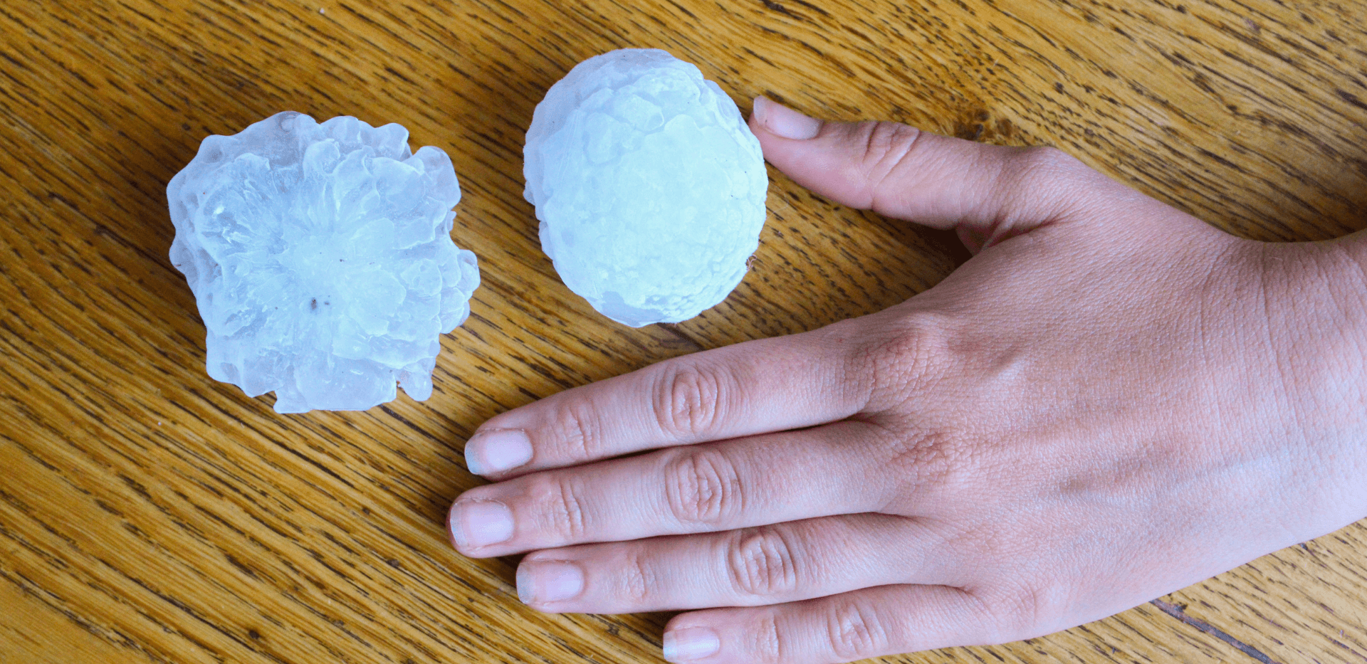 Large hailstone next to hand