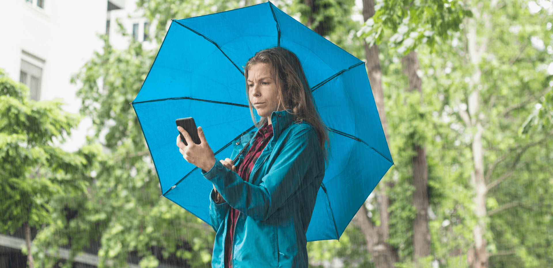 Lady checking the weather on her phone. 